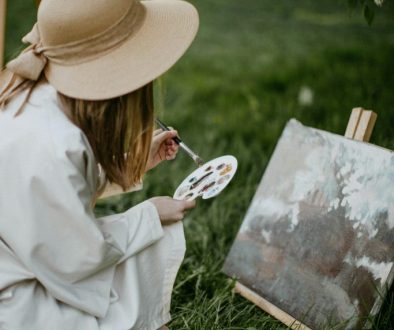 A woman sketching outdoors, surrounded by nature, symbolizing creativity as a mental escape.